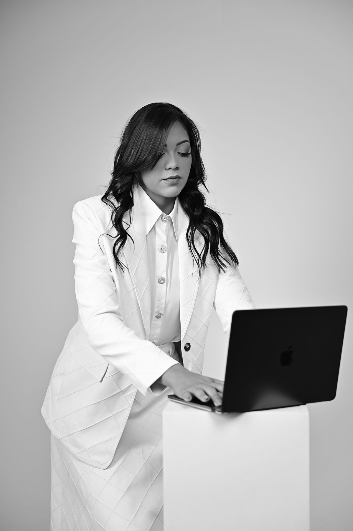 Jessyka Dumont trabalhando no notebook, foto em preto e branco
